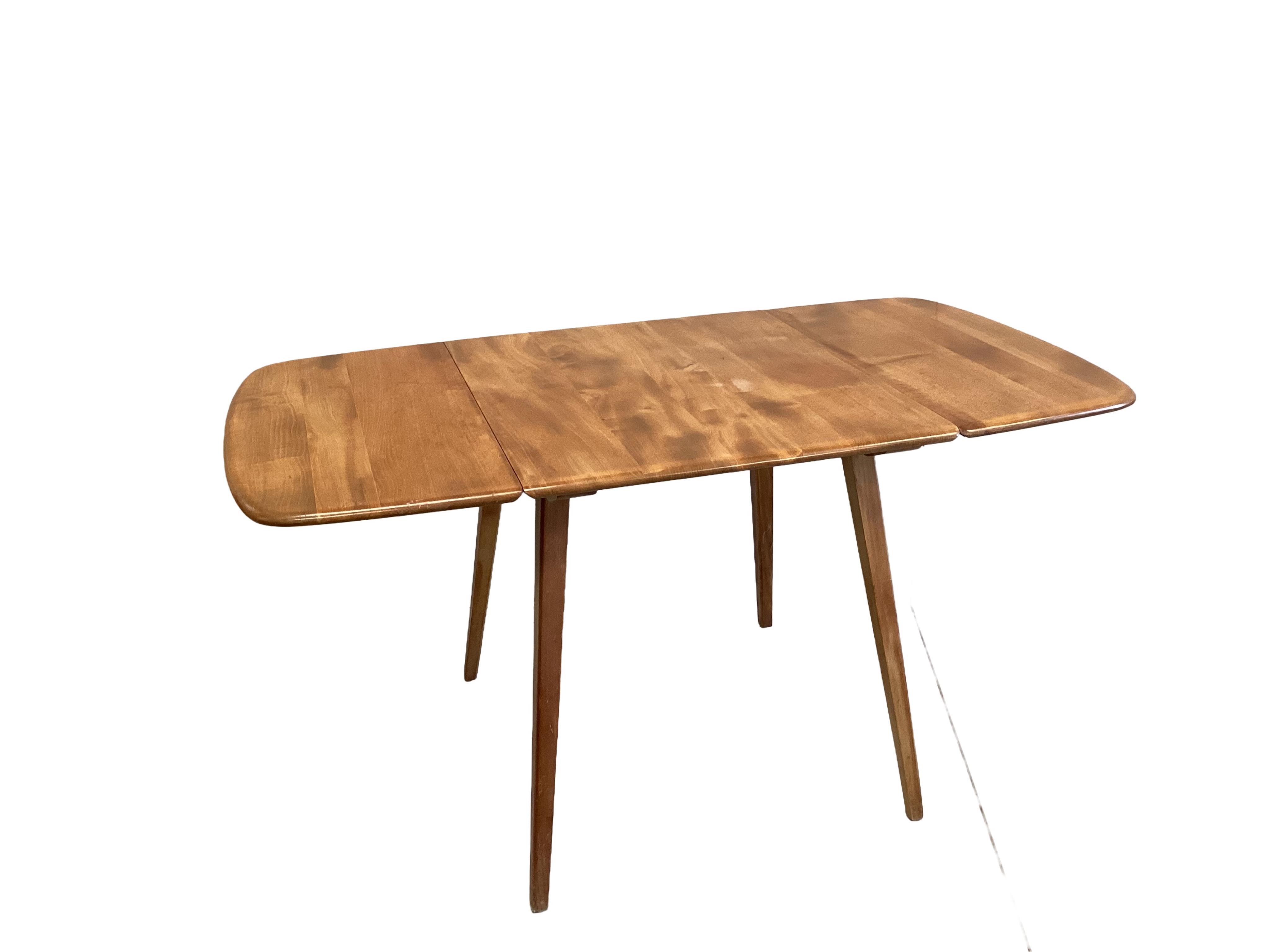 An Ercol pale elm drop leaf dining table, width 140cm extended, depth 74cm, height 71cm